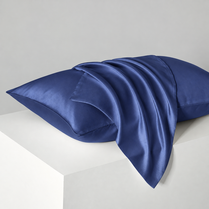 Navy satin pillowcases — diagonal studio view